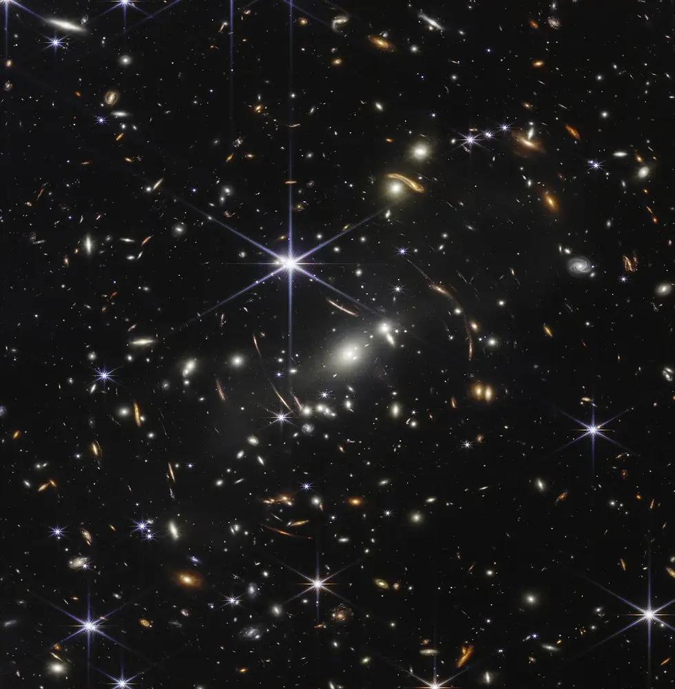 Thousands of galaxies of many colours and shapes scattered across black space
